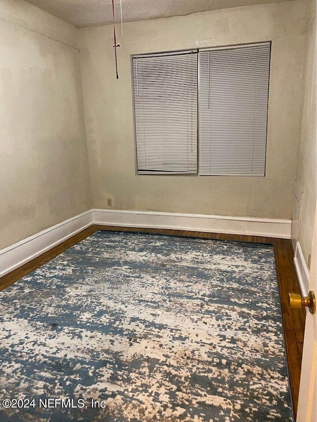 empty room featuring dark hardwood / wood-style floors