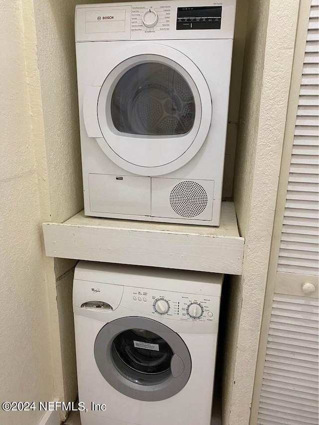 washroom with stacked washer and clothes dryer