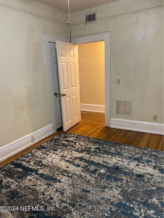 unfurnished room featuring wood-type flooring