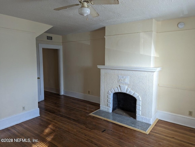 unfurnished living room with dark wood-type flooring, ceiling fan, and a textured ceiling