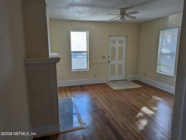 entrance foyer featuring a textured ceiling, wood-type flooring, and ceiling fan