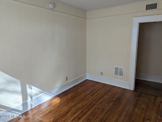 unfurnished room with dark hardwood / wood-style floors