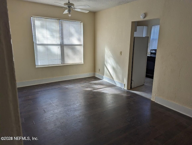 empty room featuring a textured ceiling, hardwood / wood-style flooring, and ceiling fan