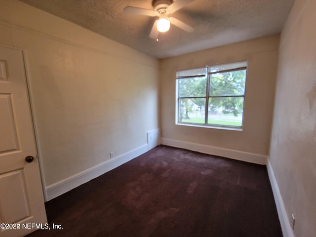 carpeted empty room with a textured ceiling and ceiling fan