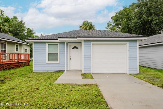 ranch-style home featuring a front lawn, a garage, and a deck