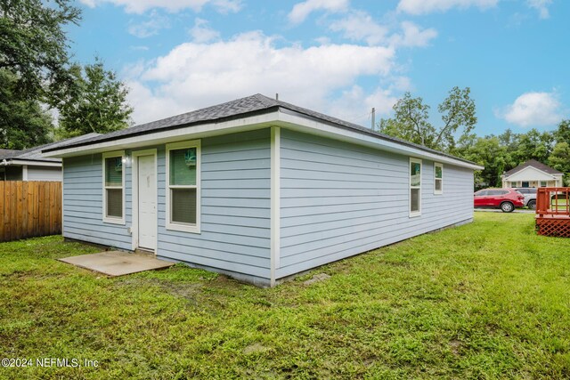 rear view of house with a yard