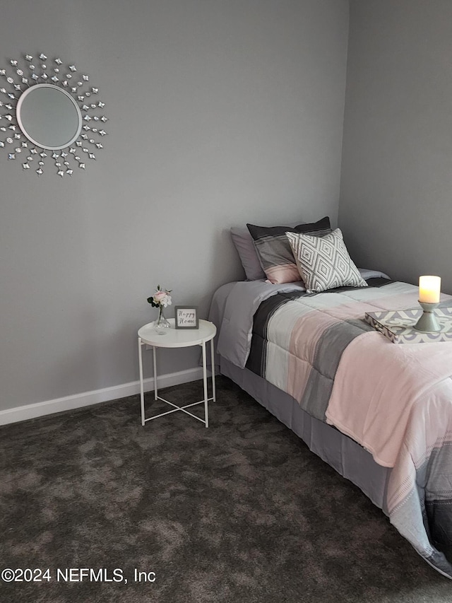 bedroom with dark colored carpet