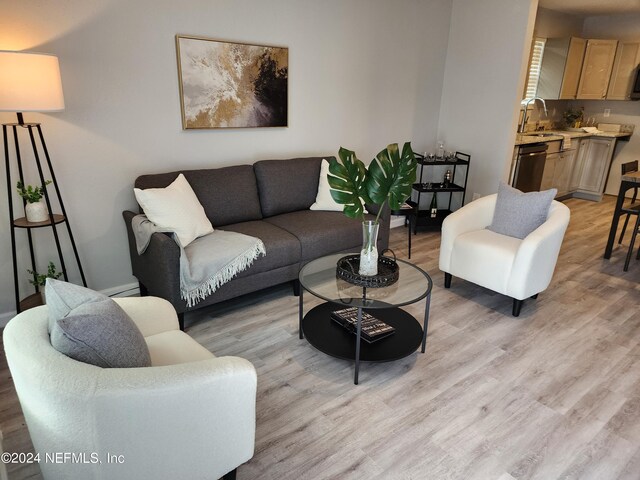 living room with sink and light hardwood / wood-style floors