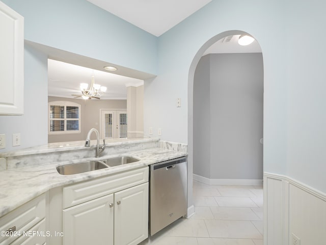 kitchen with light stone countertops, white cabinetry, sink, a notable chandelier, and stainless steel dishwasher