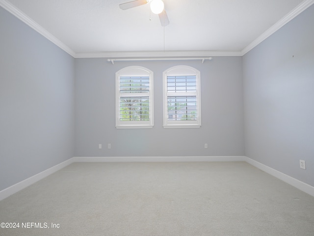 carpeted empty room featuring ornamental molding and ceiling fan