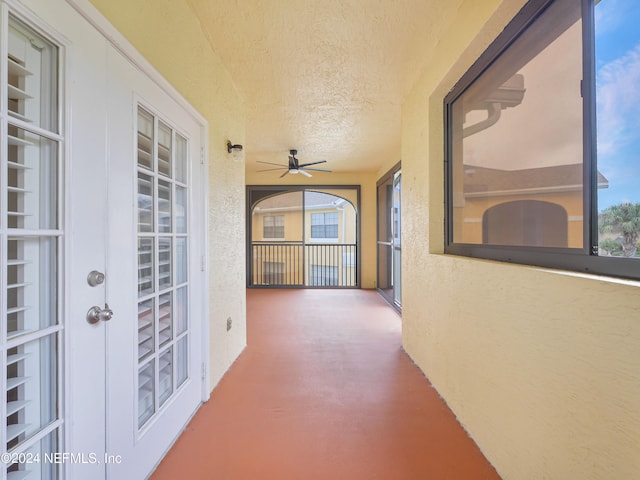 hall with a textured ceiling and concrete flooring