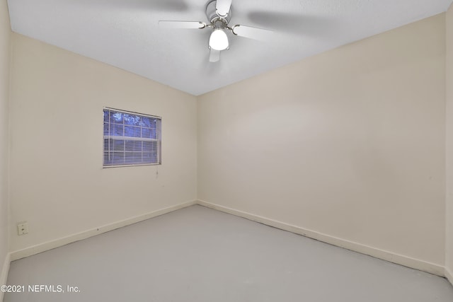 unfurnished room featuring ceiling fan and concrete floors