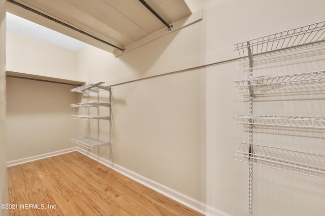 spacious closet featuring hardwood / wood-style flooring