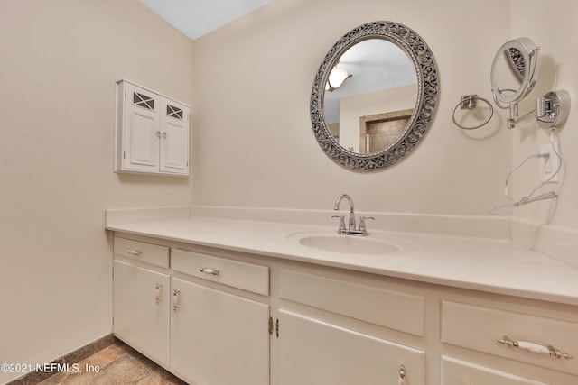 bathroom featuring vanity and vaulted ceiling