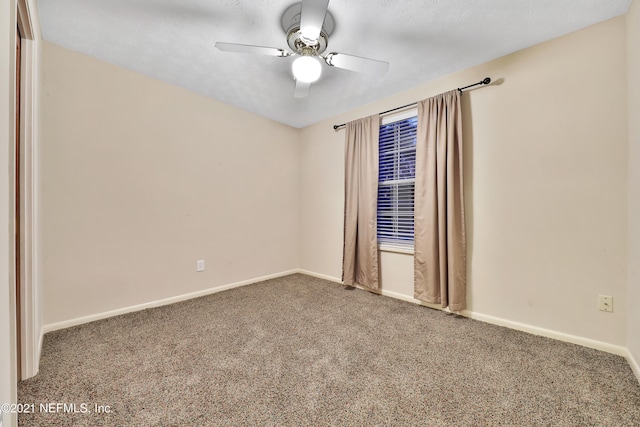 unfurnished room with ceiling fan, carpet, and a textured ceiling