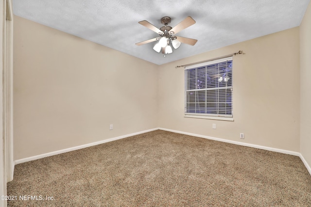 carpeted empty room featuring a textured ceiling and ceiling fan