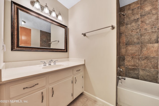 bathroom with tiled shower / bath, vanity, and tile patterned floors