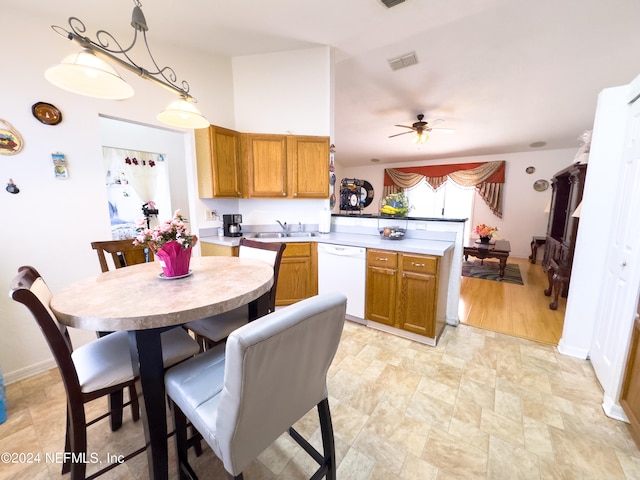 kitchen with dishwasher, light wood-type flooring, ceiling fan, decorative light fixtures, and sink