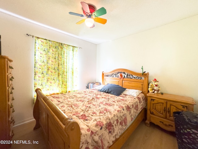 bedroom with ceiling fan and light wood-type flooring