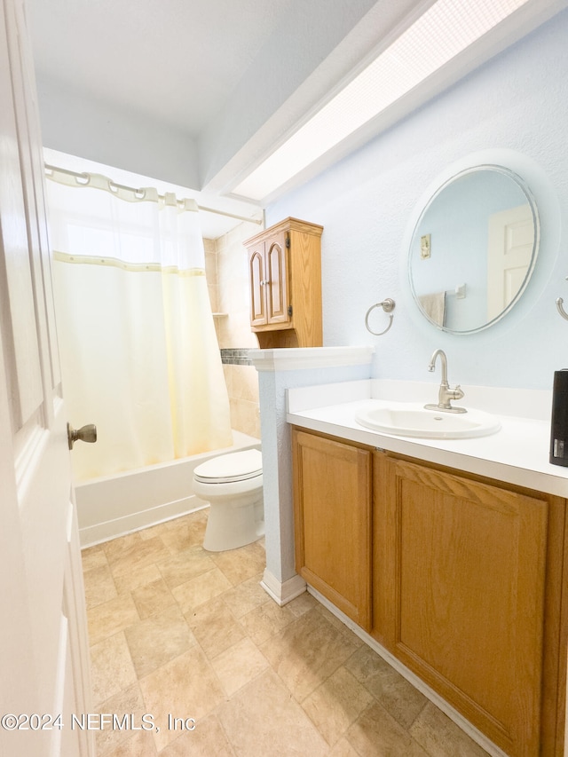 full bathroom with vanity, shower / tub combo, and toilet