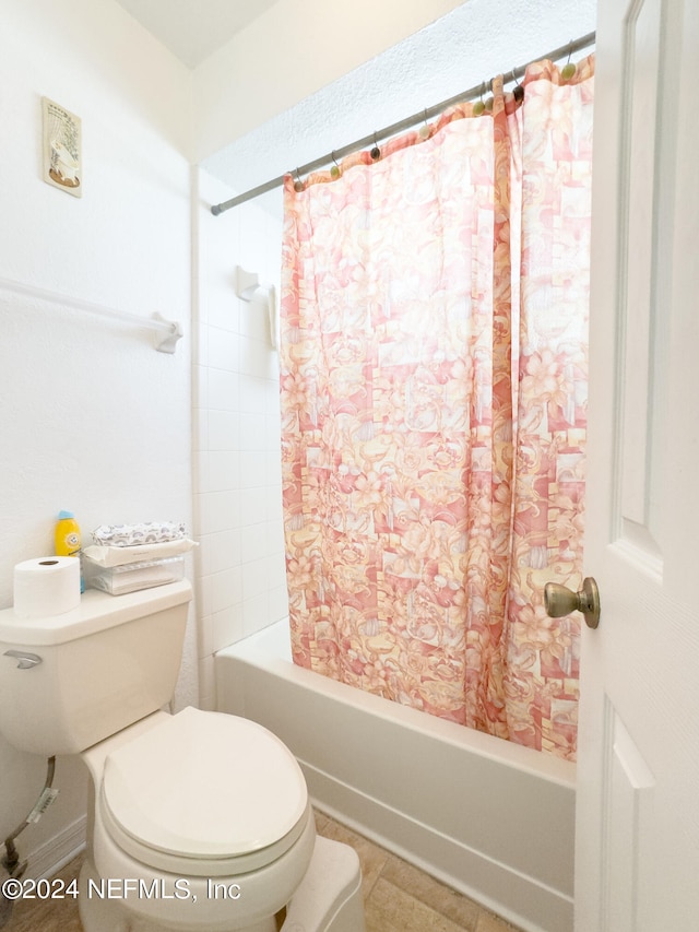 bathroom with shower / bathtub combination with curtain and toilet