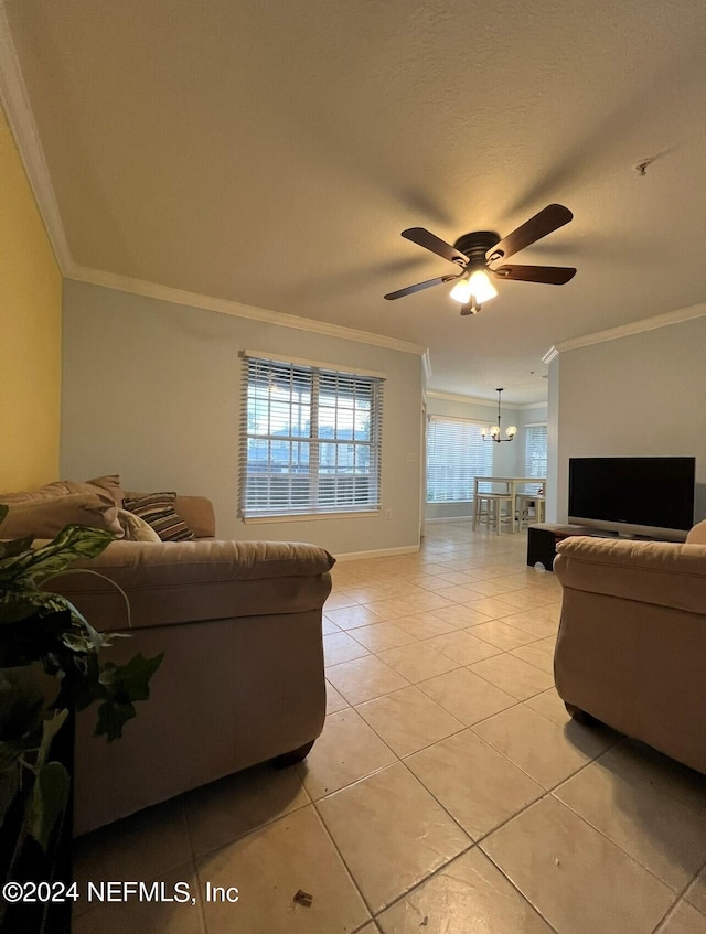 living room with ceiling fan with notable chandelier, light tile patterned floors, a textured ceiling, and ornamental molding