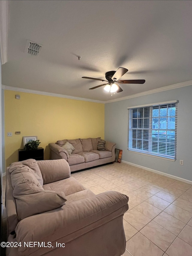 tiled living room with ornamental molding and ceiling fan