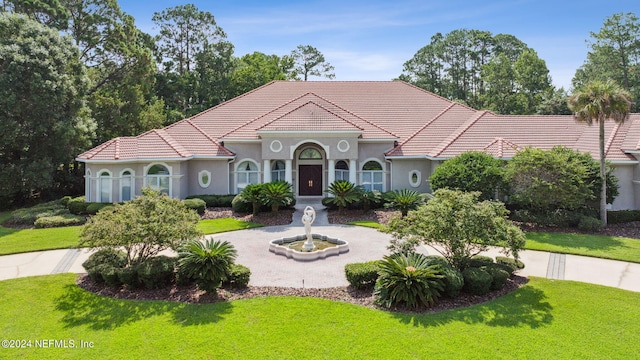 mediterranean / spanish-style home featuring a front lawn