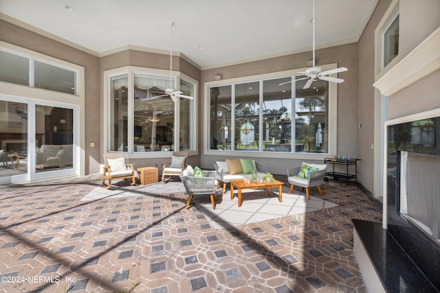 sunroom featuring ceiling fan