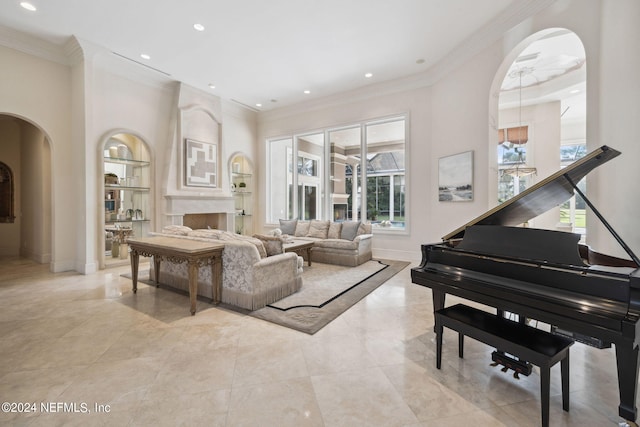 living area with a wealth of natural light, crown molding, and a large fireplace