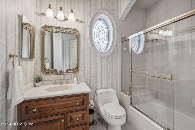 full bathroom with vanity, toilet, and shower / bath combination with glass door