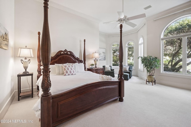 carpeted bedroom featuring ceiling fan, ornamental molding, and multiple windows