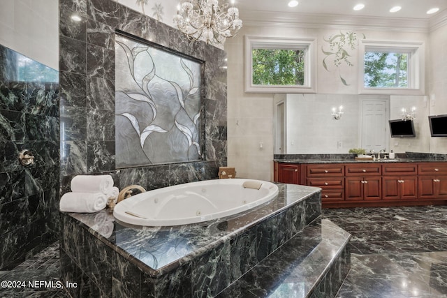 bathroom featuring vanity, ornamental molding, tile walls, and tiled bath