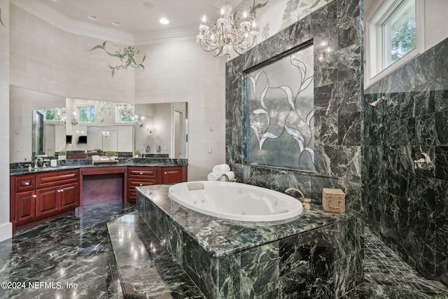 bathroom featuring tile walls, vanity, tiled tub, and plenty of natural light