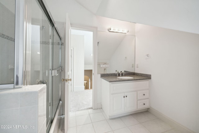 bathroom featuring vanity, vaulted ceiling, tile patterned floors, and an enclosed shower