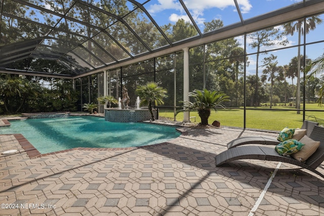 view of swimming pool with a patio area, a lanai, and pool water feature