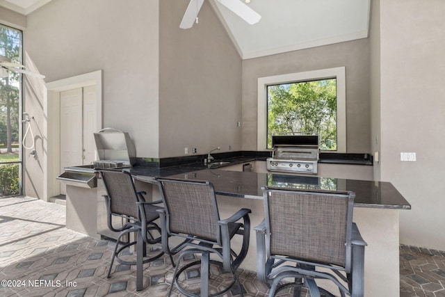 view of patio / terrace featuring area for grilling, sink, a grill, and ceiling fan