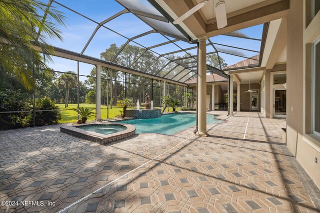 view of swimming pool featuring an in ground hot tub, a patio, a lanai, and ceiling fan