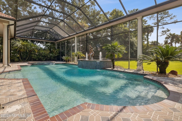 view of pool with pool water feature, a patio, and glass enclosure