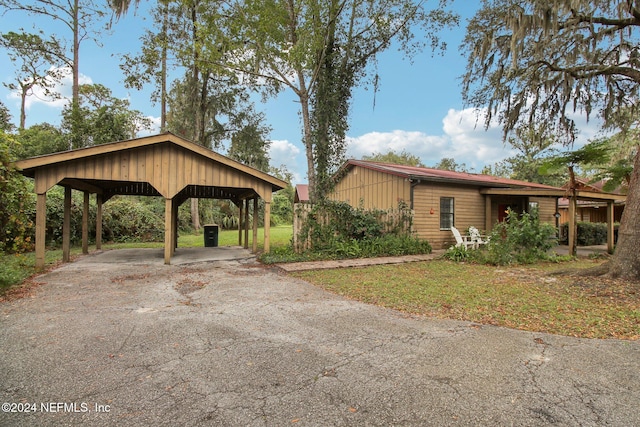 exterior space with driveway and a lawn