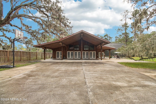 view of front of property with french doors and fence