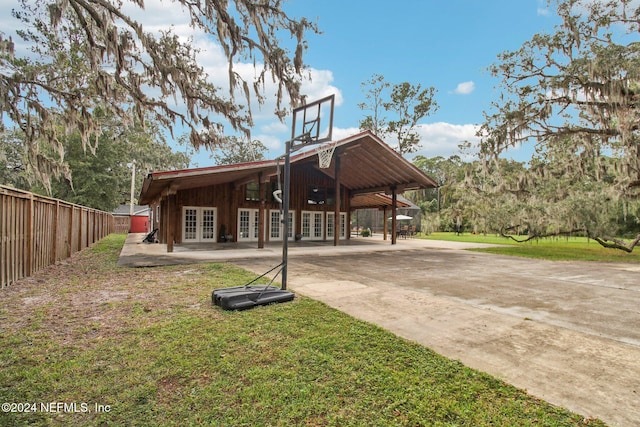 exterior space featuring a yard, french doors, and fence