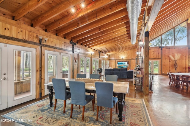 dining room with french doors, wooden ceiling, wood walls, and lofted ceiling with beams