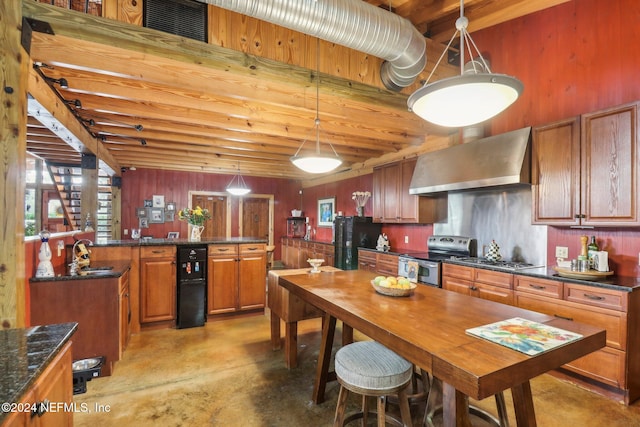 kitchen with appliances with stainless steel finishes, brown cabinets, finished concrete floors, wall chimney range hood, and a sink