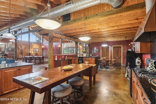 dining room with concrete flooring and wooden walls