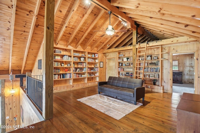 living area with wood-type flooring, lofted ceiling with beams, wood ceiling, wooden walls, and an upstairs landing