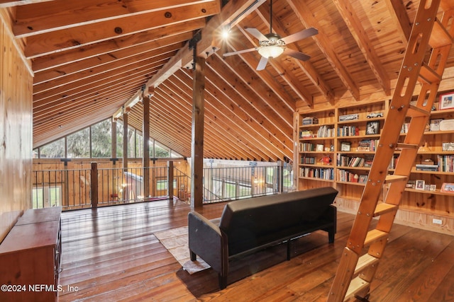 living area with lofted ceiling with beams, built in shelves, hardwood / wood-style floors, and wood ceiling