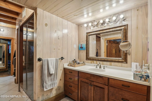 bathroom with wooden ceiling, wood walls, vanity, and tile patterned floors