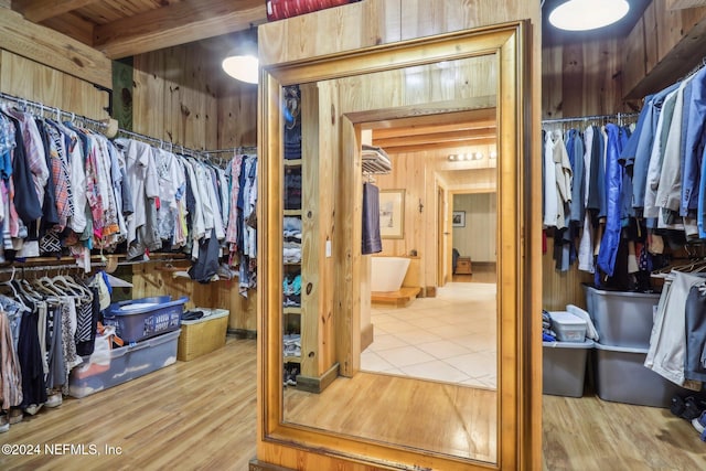 walk in closet with wood finished floors