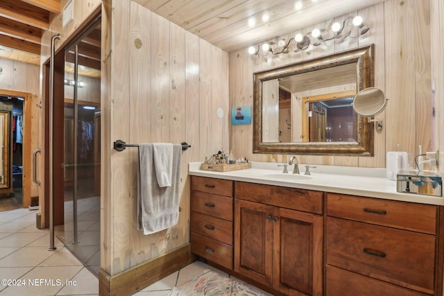 bathroom featuring wooden walls, vanity, and tile patterned floors